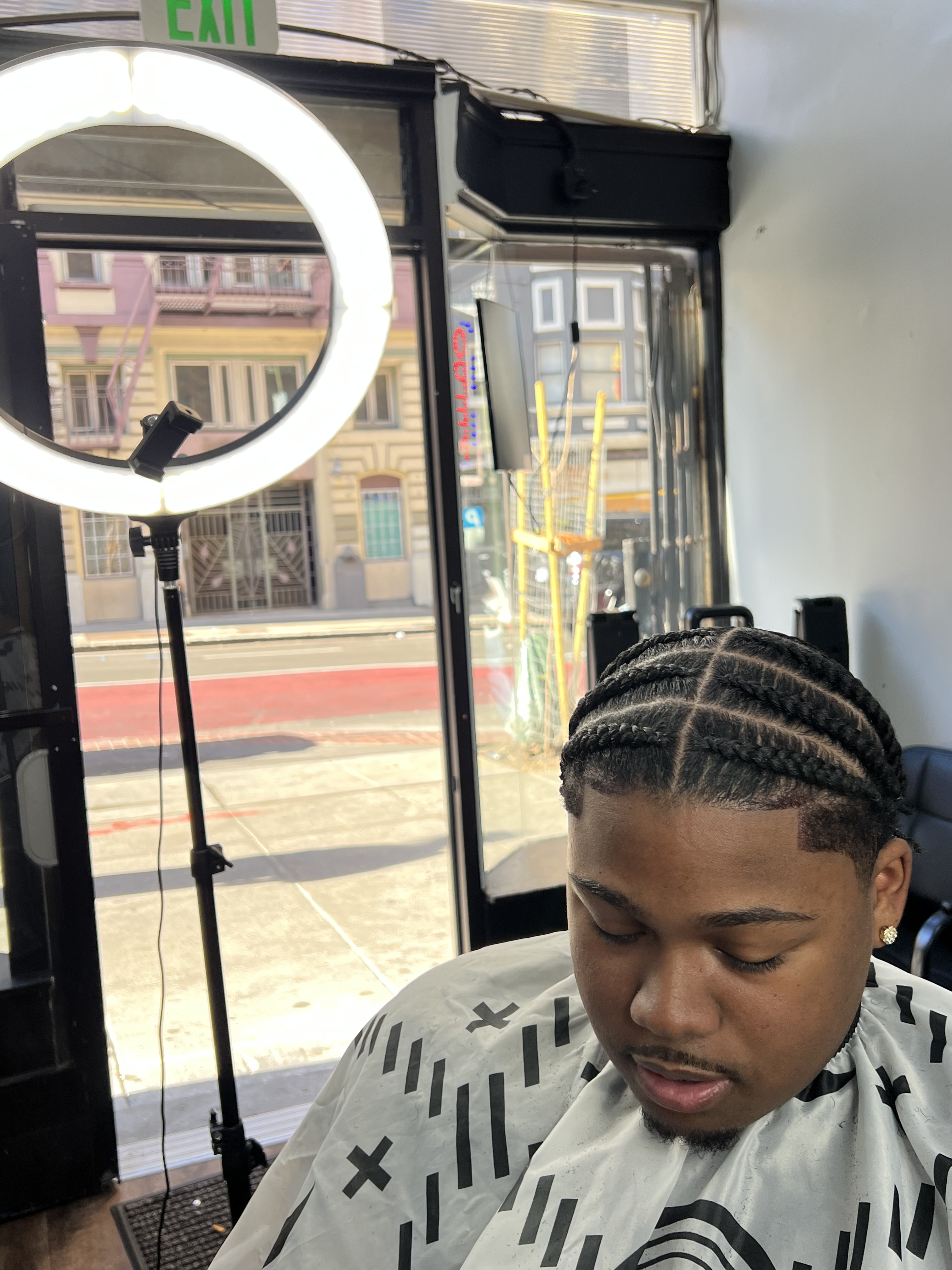 Braids service inside Golden Beauty Barbershop on O'Farrell St