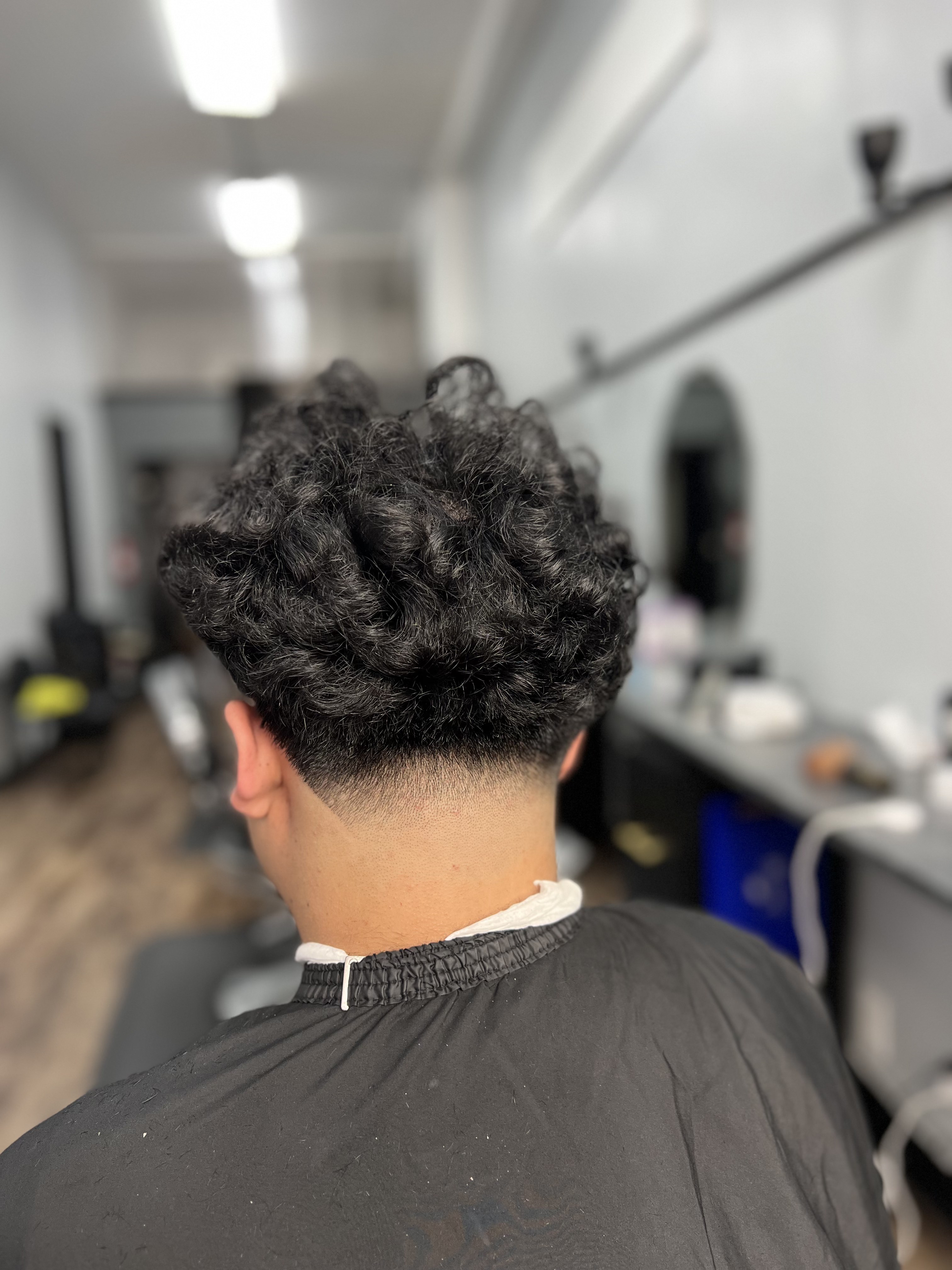 Curly fade haircut at the 441 O'Farrell St barbershop