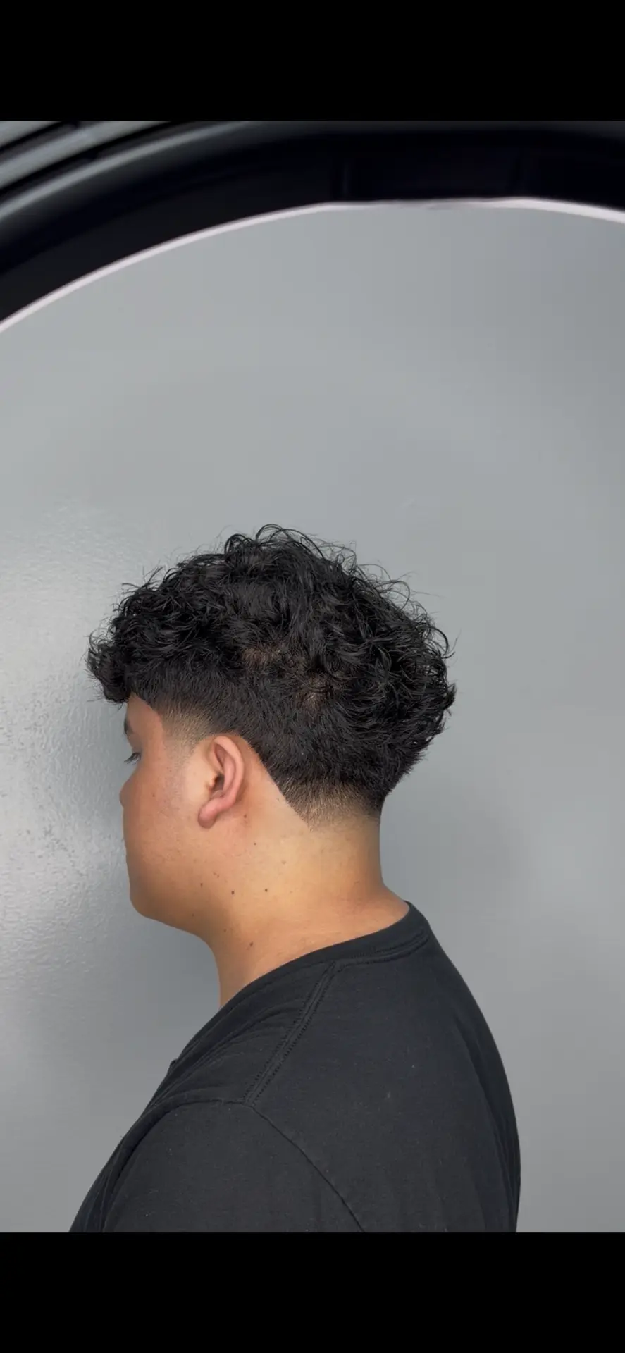 Curly taper haircut at the 441 O'Farrell St barbershop