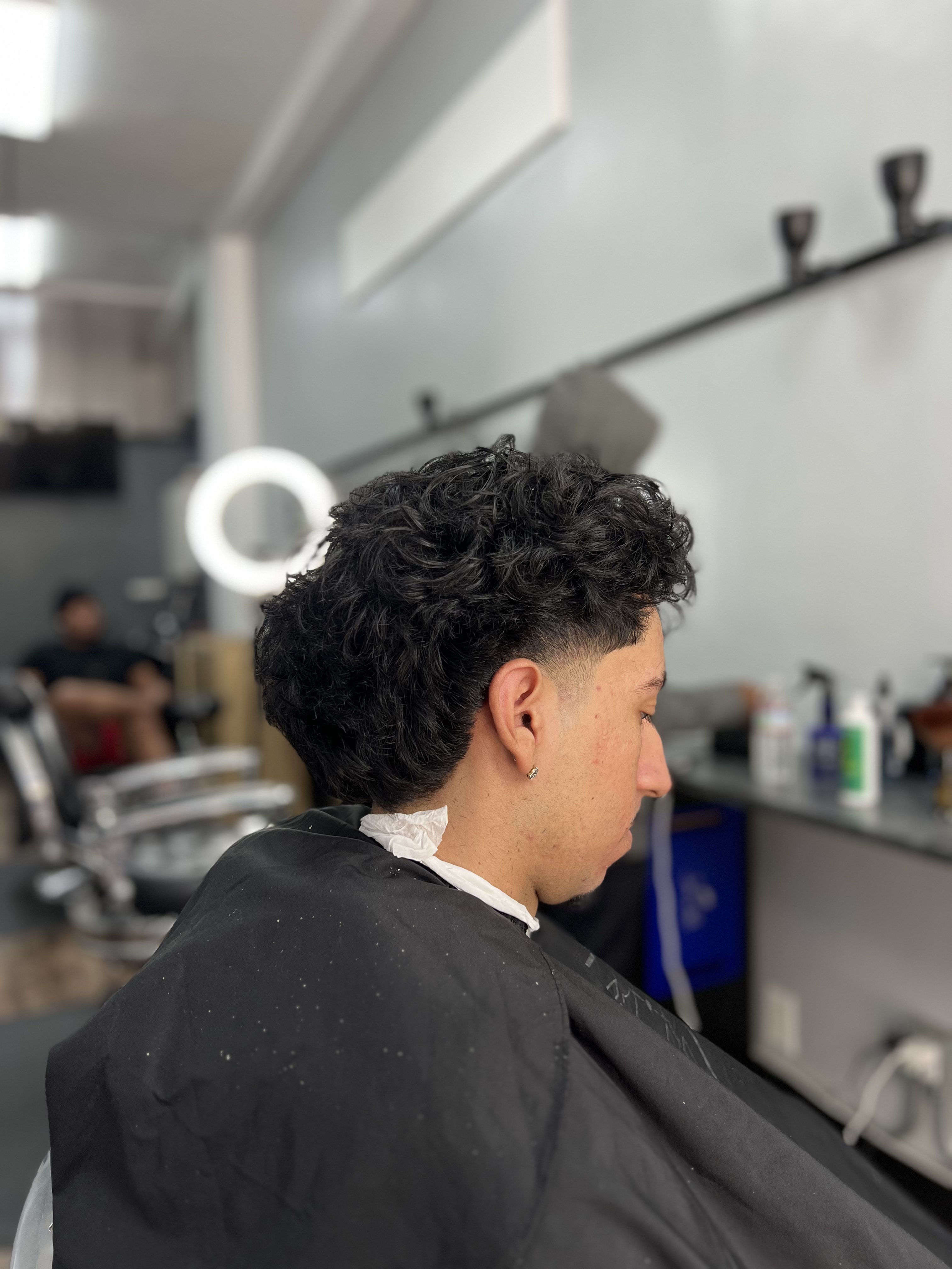 Curly textured haircut at the 441 O'Farrell St barbershop
